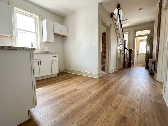 Kitchen and hallway with new wide oak-look vinyl plank flooring
